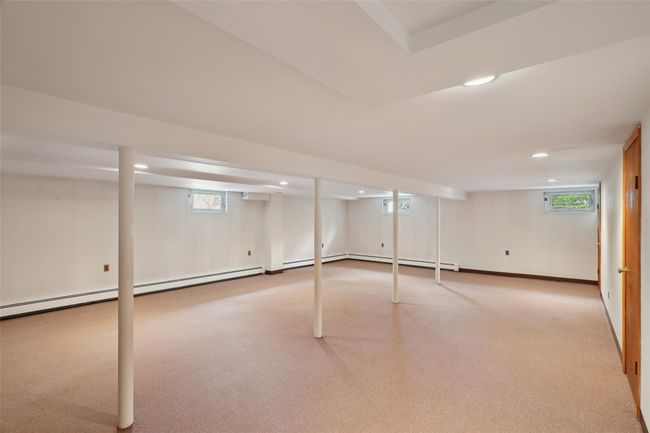 Basement featuring recessed lighting, a wealth of natural light, and carpet flooring | Image 30