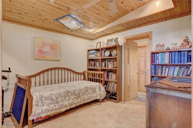 Bedroom featuring wooden ceiling and light tile patterned floors | Image 53