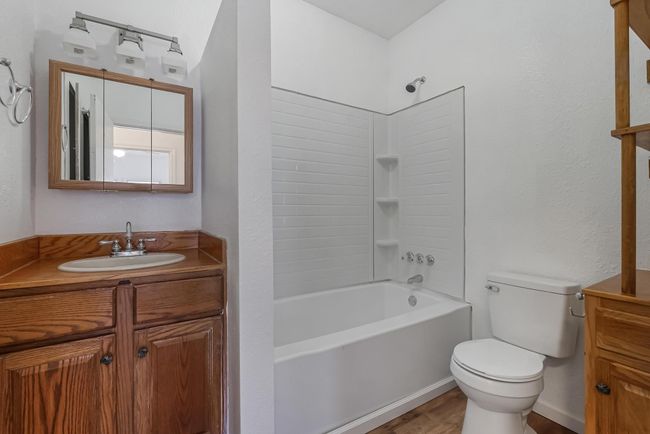 Full bathroom featuring vanity, hardwood / wood-style floors, shower combination, and toilet | Image 28