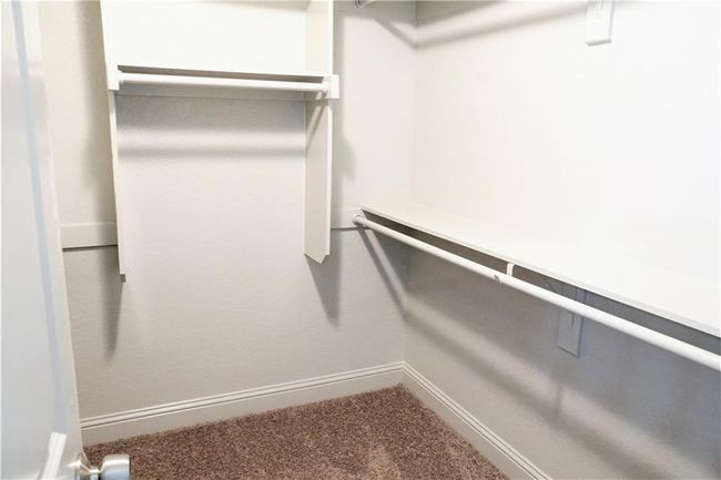 Spacious closet with carpet floors | Image 12