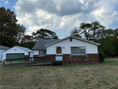 View of front of home with an outdoor structure, a garage, and a front lawn | Image 2