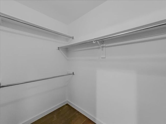 Spacious closet with wood-type flooring | Image 24