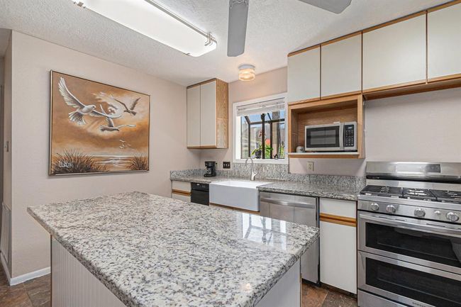 Kitchen island and updated gas range | Image 10