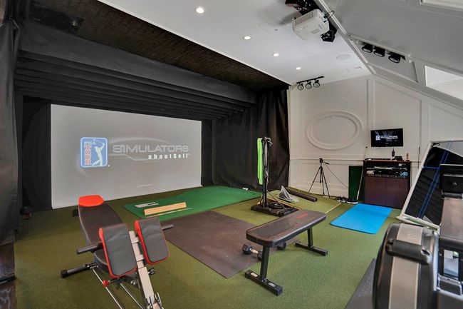 Upstairs large recreation room/exercise room featuring custom paneled walls, golf simulator and half bath | Image 30