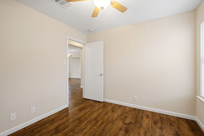 Unfurnished room with a ceiling fan and wood finished floors | Image 16