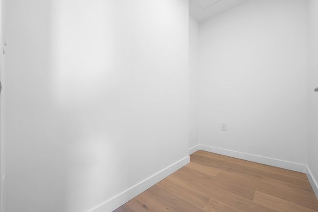 Empty room featuring light wood-type flooring and attic access | Image 15