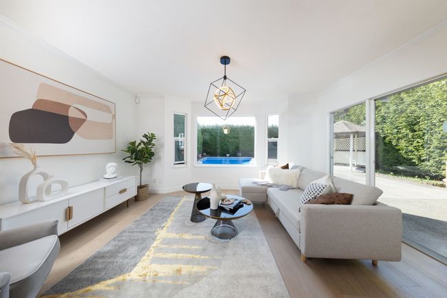Living room with baseboards, crown molding, and light wood-style flooring | Image 19