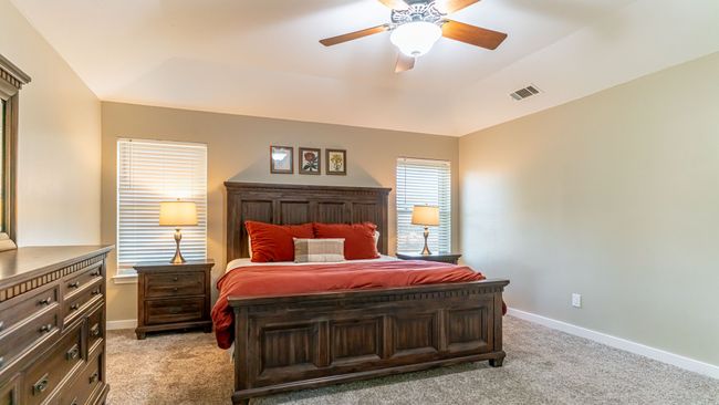 Bedroom featuring visible vents, light colored carpet, baseboards, and ceiling fan | Image 19