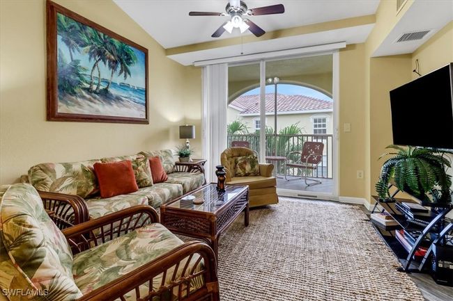 Living room with ceiling fan and wood finished floors | Image 5