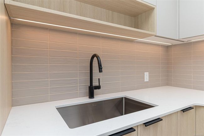 Details featuring modern cabinets, a sink, backsplash, and light brown cabinetry | Image 12