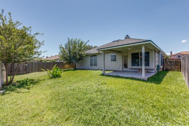 Back of house featuring a patio area, a fenced backyard, and a chimney | Image 36