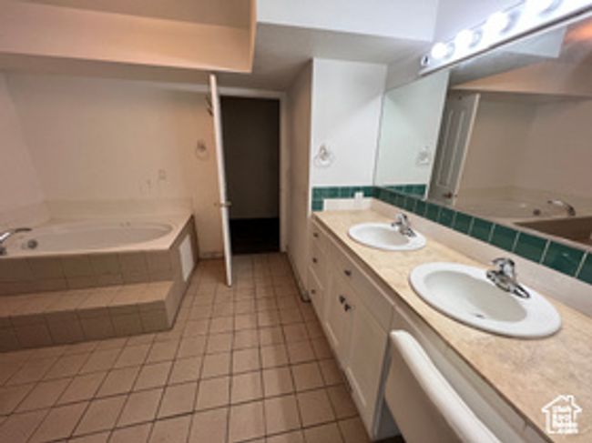 Bathroom with a bath, tile patterned floors, and double vanity | Image 6