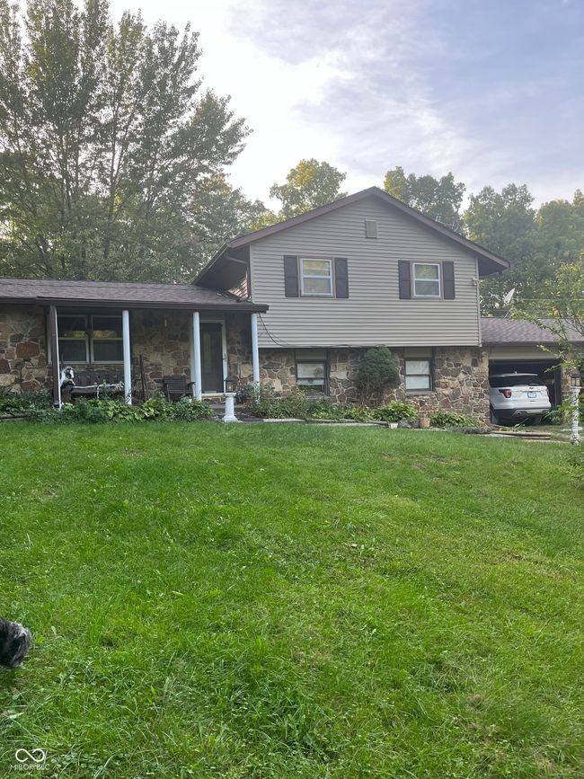 split level home with an attached carport and gravel driveway | Image 10