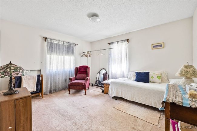 Bedroom with a textured ceiling and light carpet | Image 16