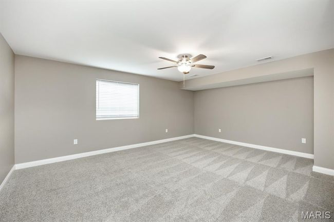 Lower Level bedroom with walk in closet and carpet | Image 26