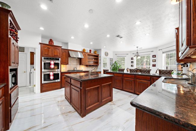 Bright kitchen with an island and ample counter space | Image 9
