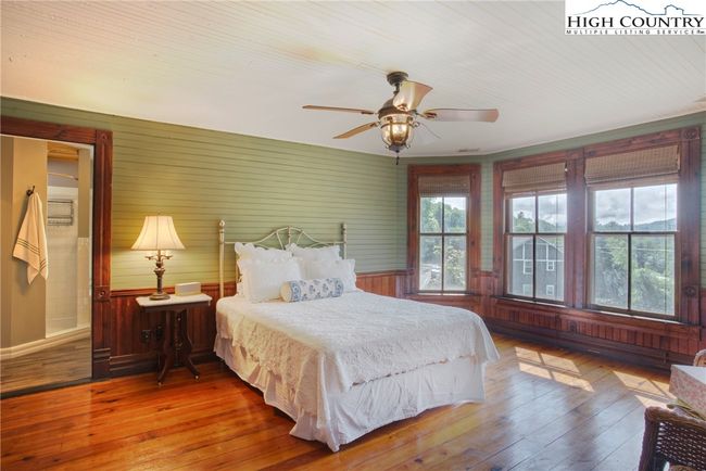 Large primary bedroom with beautiful lighting and windows. | Image 23