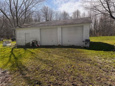 Garage featuring a lawn | Image 2