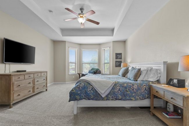 Graciously scaled and filled with light, the primary bedroom offers peaceful seclusion and space to unwind. | Image 18