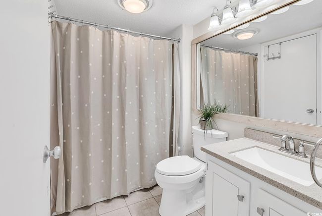 Full bath featuring vanity, tile patterned floors, visible vents, and toilet | Image 18