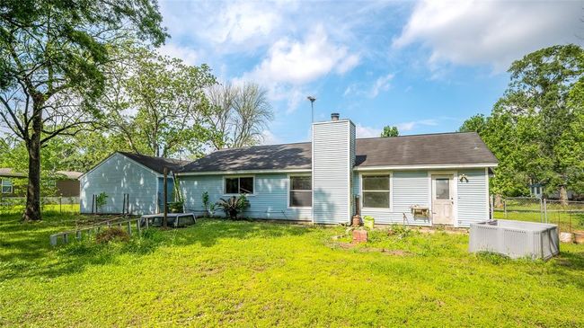 Expansive backyard with lush greenery, offering plenty of space for outdoor activities and relaxation. | Image 9