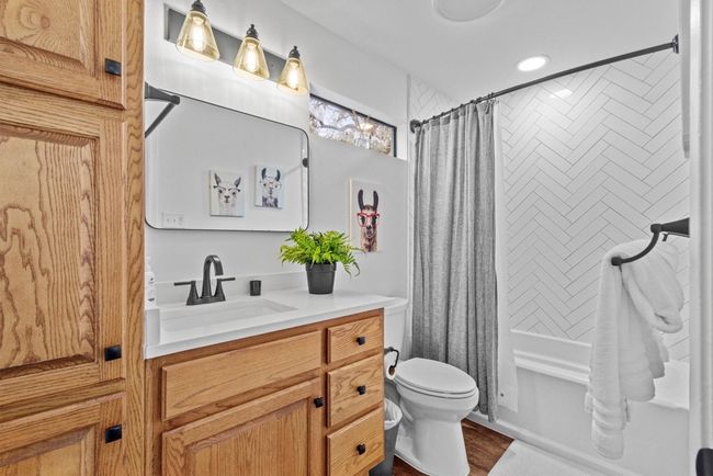 Full bathroom featuring hardwood / wood-style flooring, toilet, vanity, and shower / bath combination with curtain | Image 17