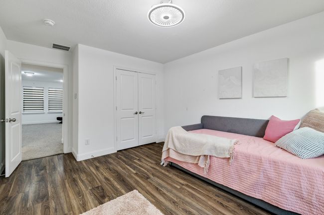 Bedroom with dark wood-type flooring and a closet | Image 21