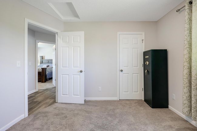 Third bedroom on the upper level provides versatile space, ideal for guests, a home office, or a growing family. | Image 24