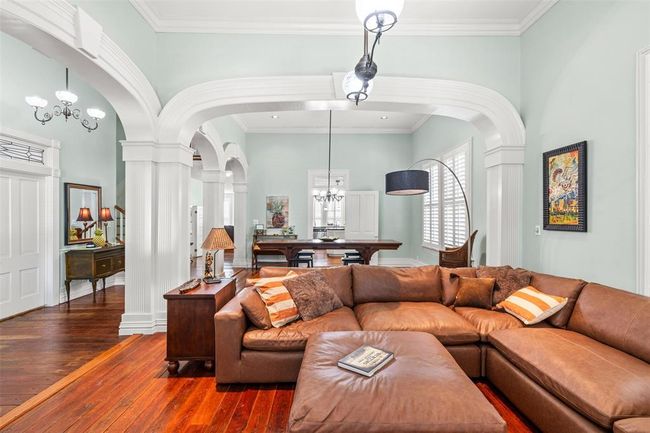 Relax in elegance in this living area, boasting architectural charm and a warm, inviting ambiance. | Image 4