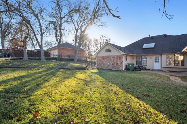 Large backyard with garage entrance in the back. | Image 36