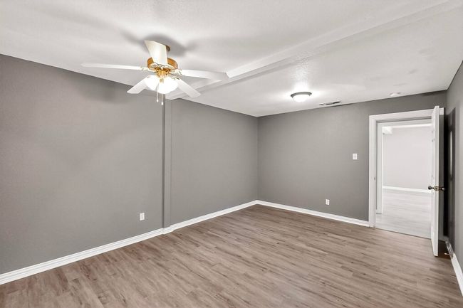 Empty room featuring ceiling fan and wood finished floors | Image 18