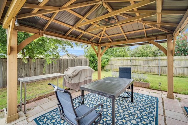 Fenced backyard with a gazebo, a patio, outdoor dining area, and area for grilling | Image 31
