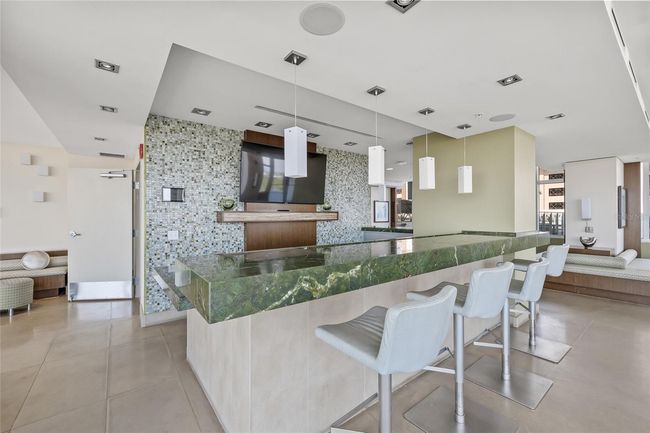 Kitchen, bar and multiple seating areas with views of the water | Image 61