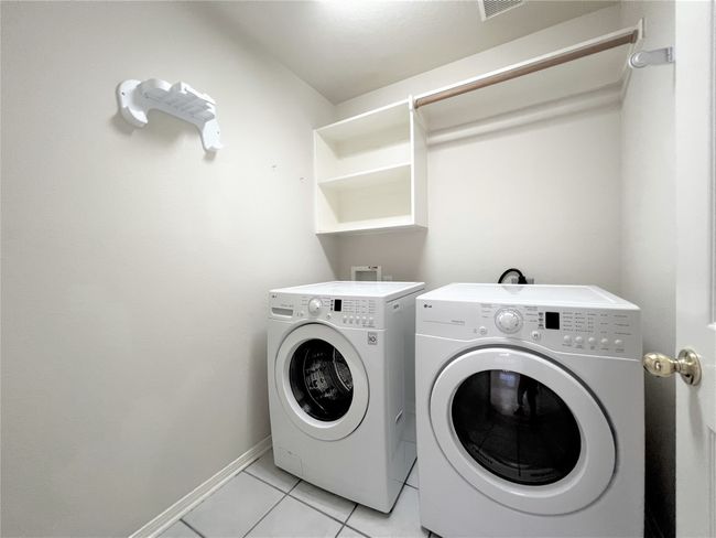 Washroom featuring independent washer and dryer and light tile patterned floors | Image 15