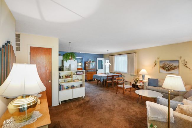 living area with dark colored carpet | Image 11
