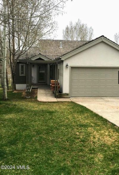 Front of Home with extra parking spaces and 2 car Garage. | Image 1