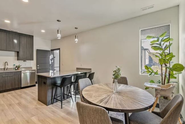 Dining area featuring light wood-style flooring, visible vents, and recessed lighting | Image 65