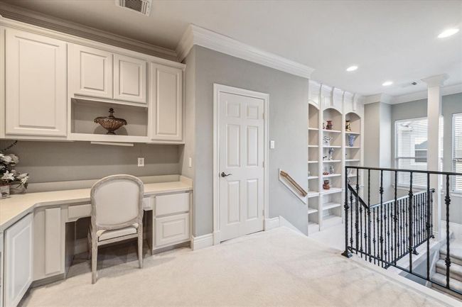 Ideal student area, craft room, or upstairs study for two located off the gameroom. Custom bookshelf was added off the 2nd stairwell. | Image 27