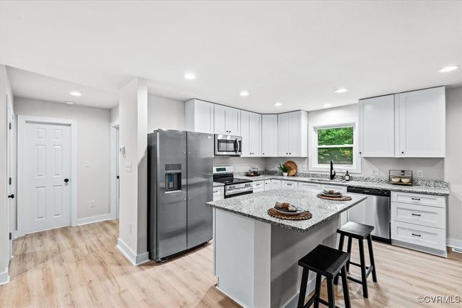 White cabinets, soft close, granite counters, large island (2 bedrooms and full bathroom beyond) | Image 7