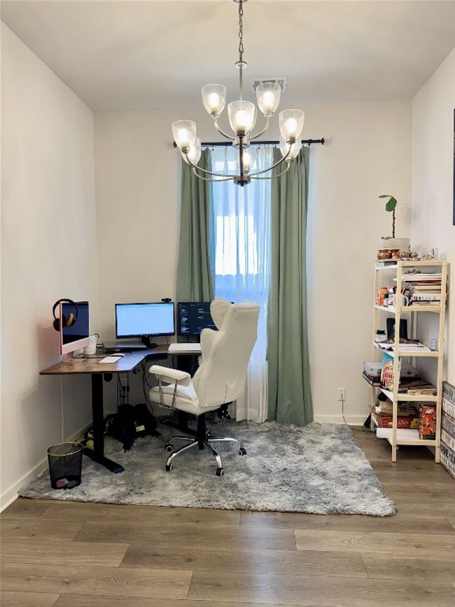 Office area featuring a chandelier, wood finished floors, and baseboards | Image 16