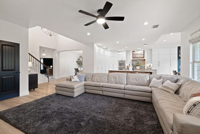 Living area featuring visible vents, stairs, ceiling fan, recessed lighting, and light wood finished floors | Image 19