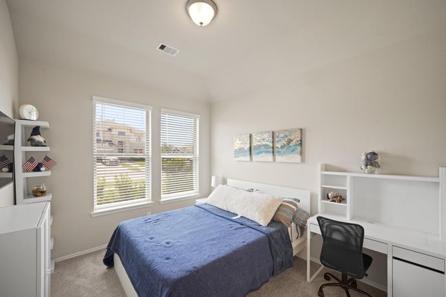 Secondary bedroom features largewindows and plush carpet. | Image 25