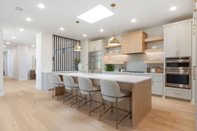 Kitchen featuring visible vents, light countertops, appliances with stainless steel finishes, a skylight, and open shelves | Image 4