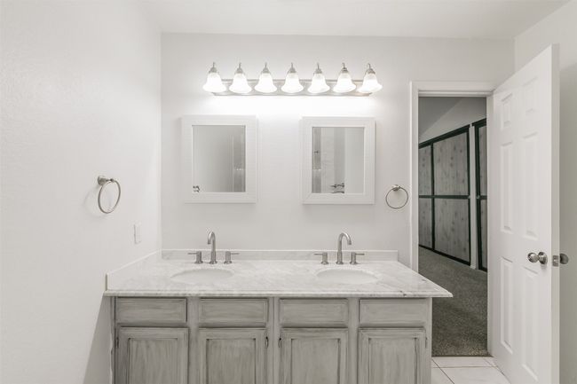 Full bath with double vanity and tile patterned flooring | Image 23