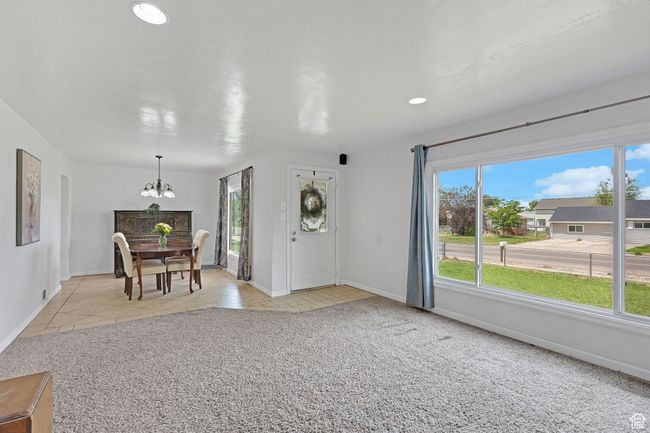 Dining room featuring a chandelier, plenty of natural light, baseboards, light tile patterned floors, and recessed lighting | Image 7
