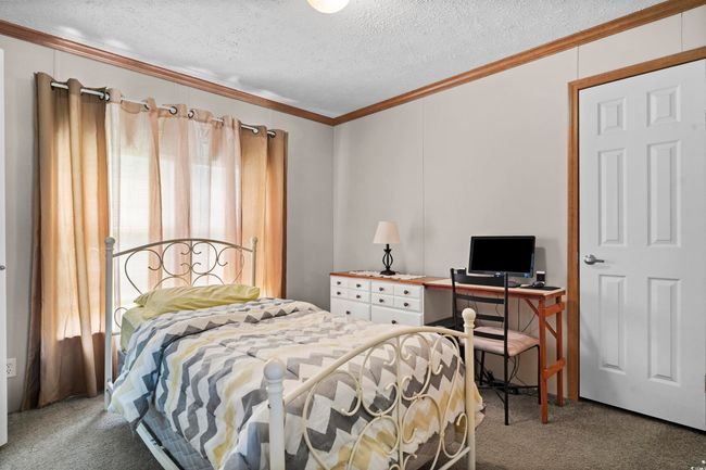 Carpeted bedroom featuring ornamental molding and a textured ceiling | Image 37