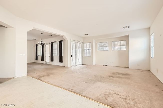Empty room featuring a chandelier and visible vents | Image 13
