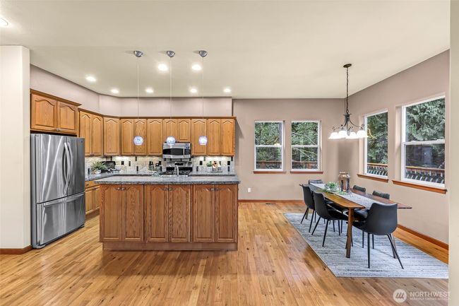 Granite countertops have blue specs to glisten the kitchen | Image 9