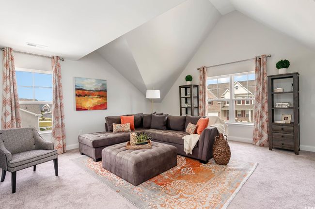 Living area with light colored carpet, vaulted ceiling, and plenty of natural light | Image 21