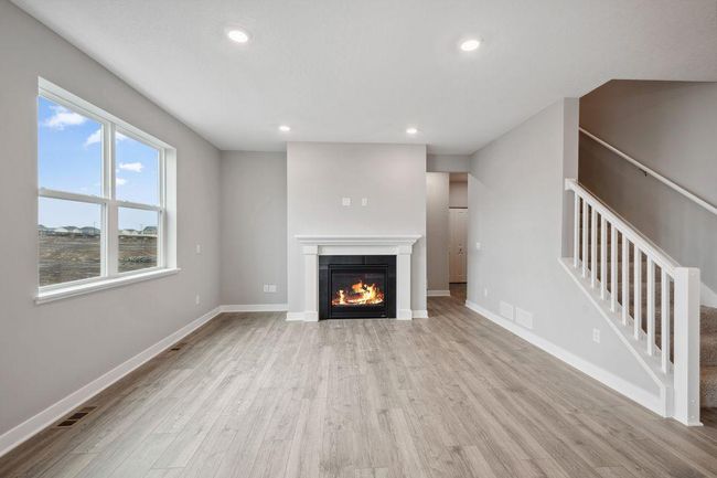 Spacious living room with electric fireplace (not shown). Model photo. Options and colors will vary. | Image 14